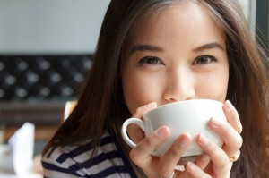 Close up portrait of woman drinking coffee