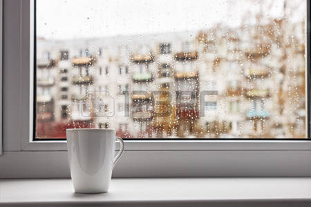 29781558-cup-of-hot-coffee-on-the-window-sill-wet-from-the-rain